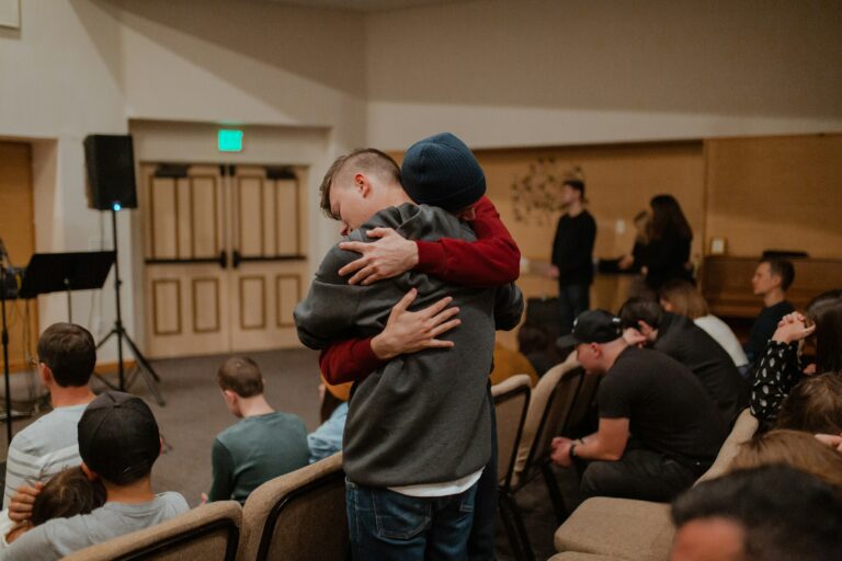 Group Therapy session with men in a room hugging