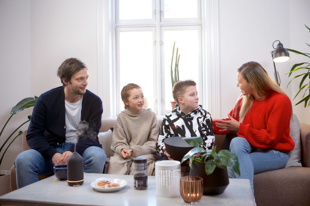 Family sitting on couch talking. Family therapy before the holidays